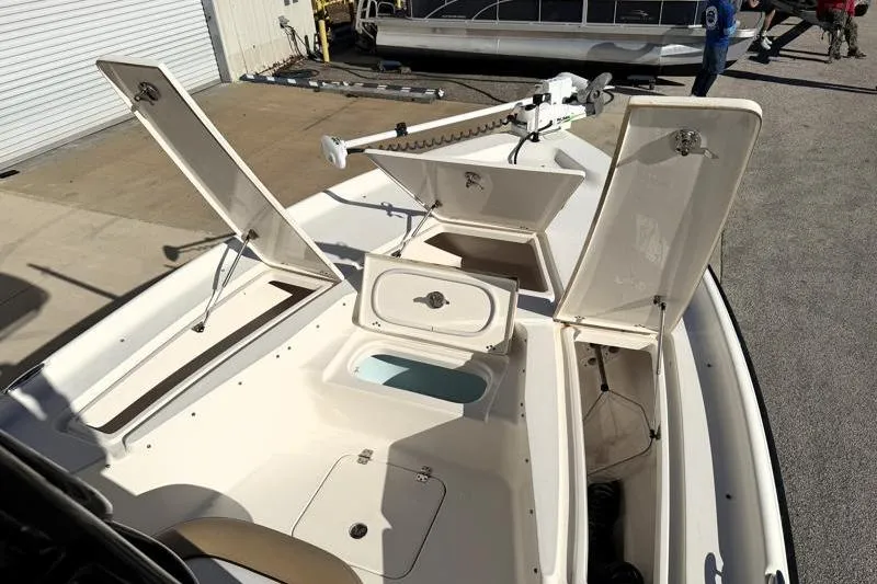 Slide: The Image of 2016 Key West 230 Bay Reef boat with open storage compartments and trolling motor. - 26