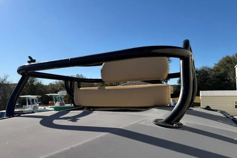 Slide: The Image of 2016 Key West 230 Bay Reef boat with cushioned seating and blue sky background. - 27