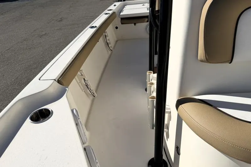 Slide: The Image of 2016 Key West 230 Bay Reef boat interior with beige seating and rod holders. - 30