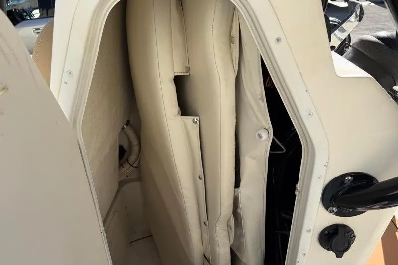 Slide: The Image of 2016 Key West 230 Bay Reef boat storage compartment with beige cushions. - 34