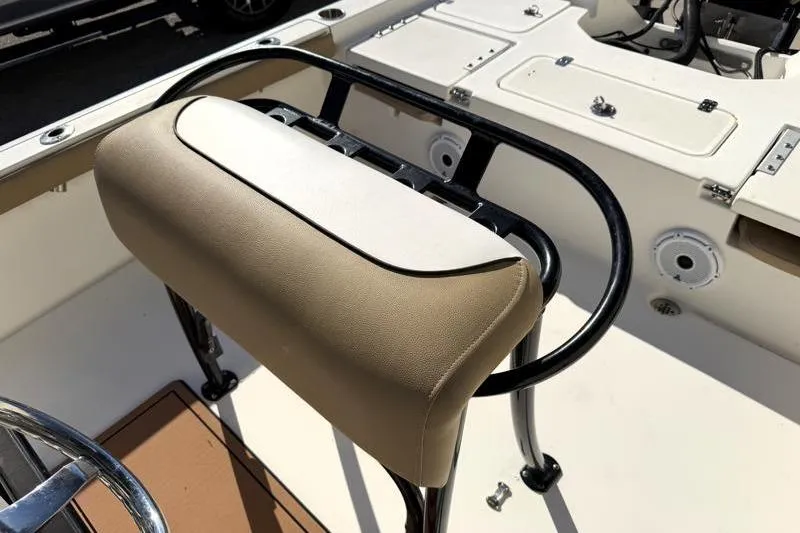 Slide: The Image of 2016 Key West 230 Bay Reef boat interior with cushioned seating and control panel. - 35