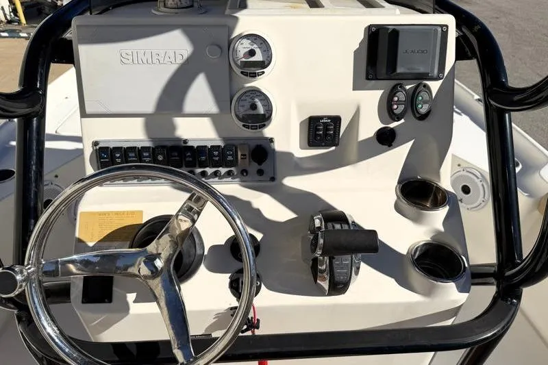 Slide: The Image of 2016 Key West 230 Bay Reef boat dashboard with steering wheel and controls. - 37