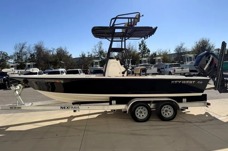 Slide: The Image of 2016 Key West 230 Bay Reef boat on trailer, side view, outdoors. - 4