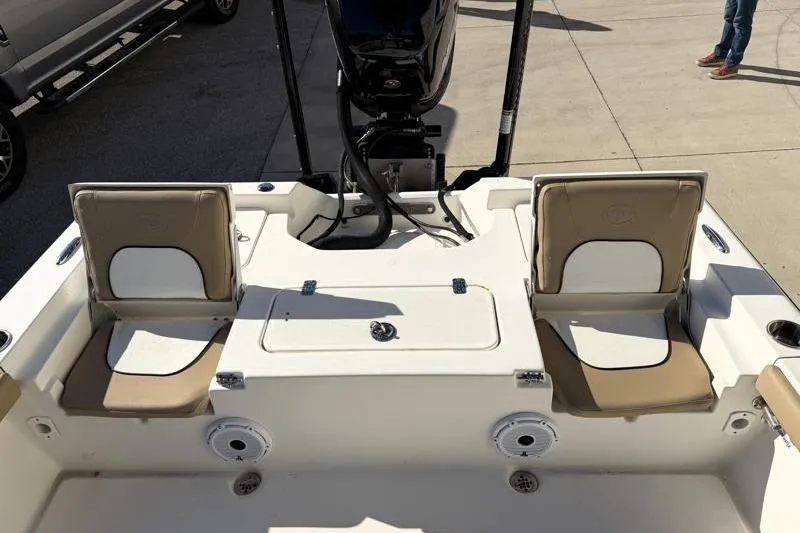 Slide: The Image of 2016 Key West 230 Bay Reef boat interior with seating and motor. - 44