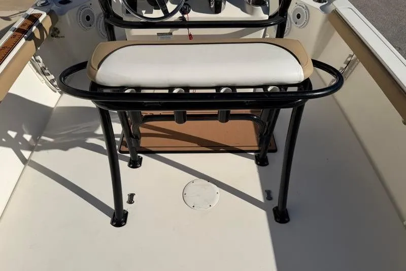 Slide: The Image of 2016 Key West 230 Bay Reef boat interior with cushioned seating and steering console. - 46