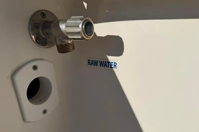 Slide: The Image of 2016 Key West 230 Bay Reef raw water outlet with valve and label. - 49