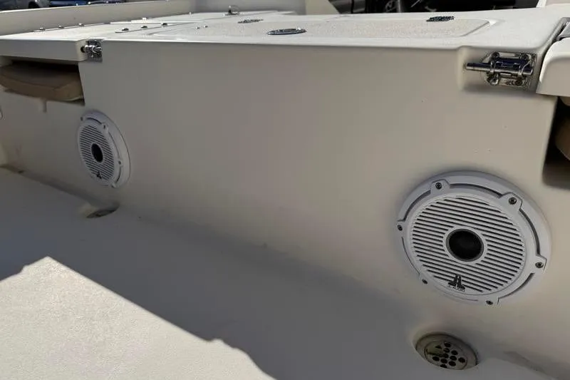 Slide: The Image of 2016 Key West 230 Bay Reef boat interior with speakers and storage compartments. - 50