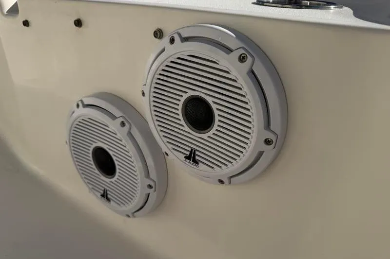 Slide: The Image of 2016 Key West 230 Bay Reef boat speakers, white and circular, mounted on the interior. - 52