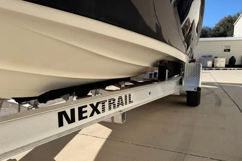 Slide: The Image of 2016 Key West 230 Bay Reef boat on a NexTrail trailer in a sunny driveway. - 55