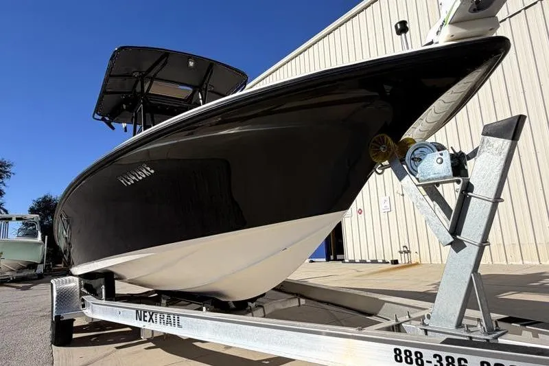 Slide: The Image of 2016 Key West 230 Bay Reef boat on trailer, parked outside a building. - 8