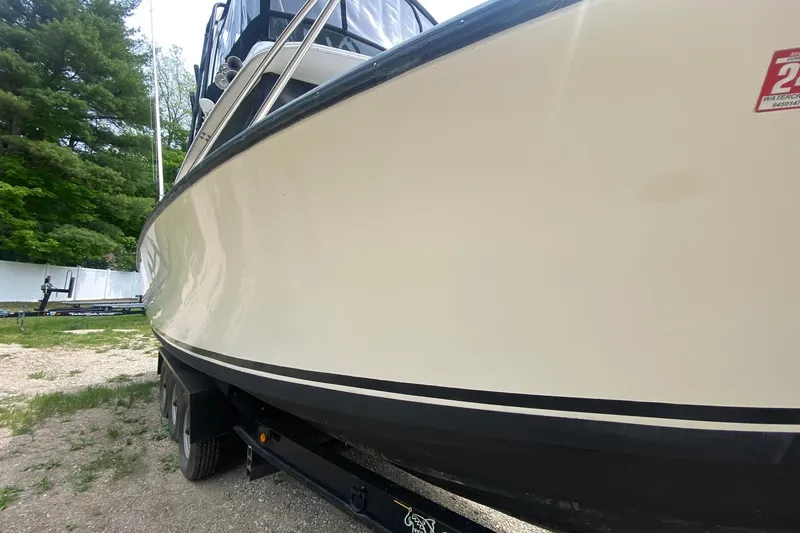 Slide: The Image of 1977 Bertram 28 Flybridge boat on trailer, side view, outdoors. - 13