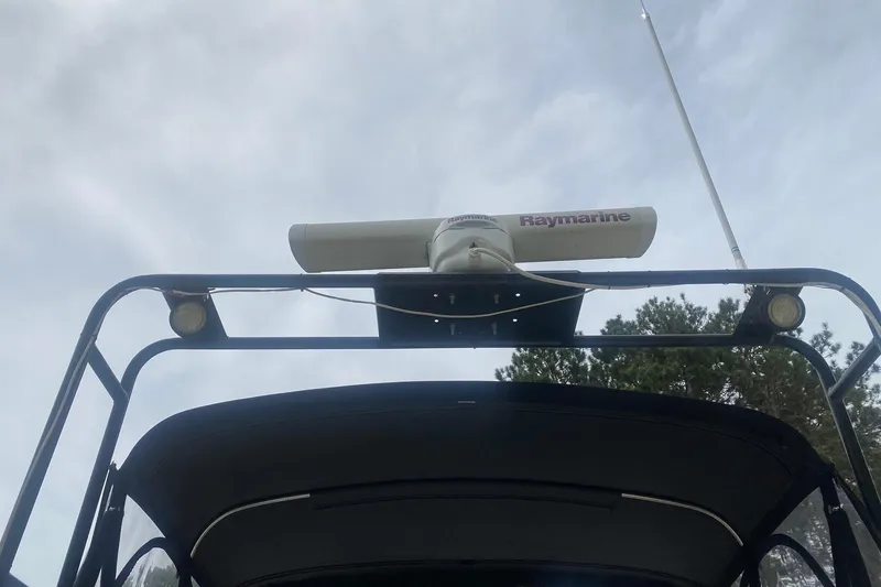 Slide: The Image of 1977 Bertram 28 Flybridge with Raymarine radar and antenna against cloudy sky. - 14