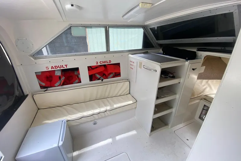 Slide: The Image of Interior of a 1977 Bertram 28 Flybridge with seating, life jackets, and storage. - 17
