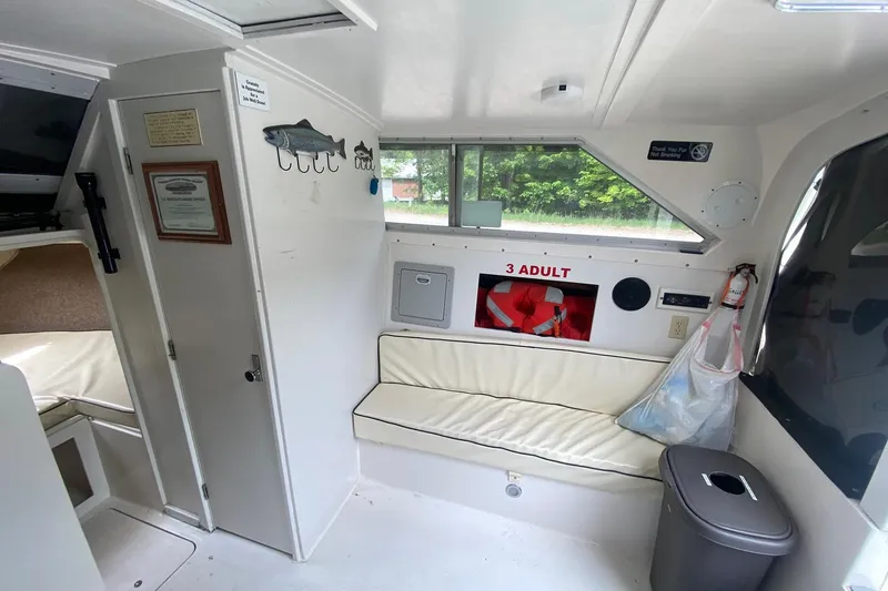 Slide: The Image of Interior of a 1977 Bertram 28 Flybridge boat with seating and safety equipment. - 18