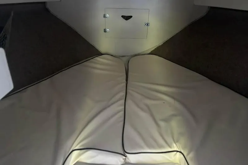 Slide: The Image of Interior cabin view of a 1977 Bertram 28 Flybridge boat with cushioned seating. - 19