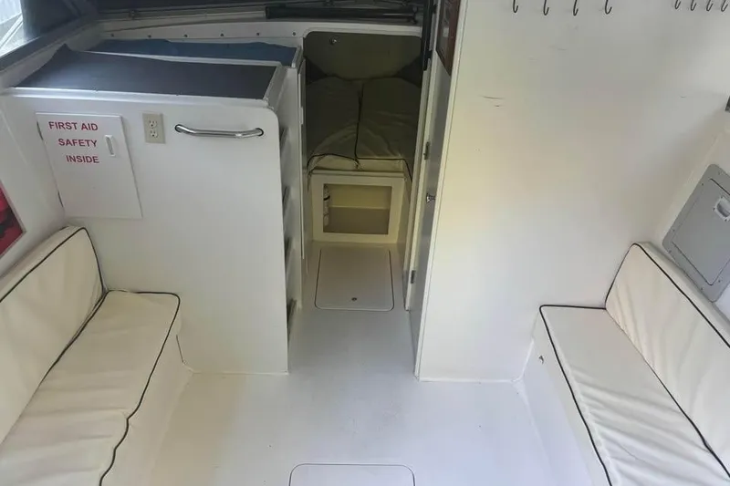 Slide: The Image of 1977 Bertram 28 Flybridge interior with seating, first aid kit, and sleeping area. - 20