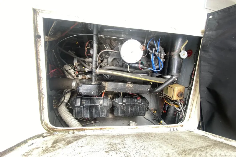 Slide: The Image of 1977 Bertram 28 Flybridge engine compartment with visible wiring and components. - 26