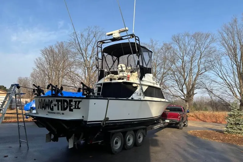 Slide: The Image of 1977 Bertram 28 Flybridge boat on trailer, Traverse City, MI, clear sky background. - 4