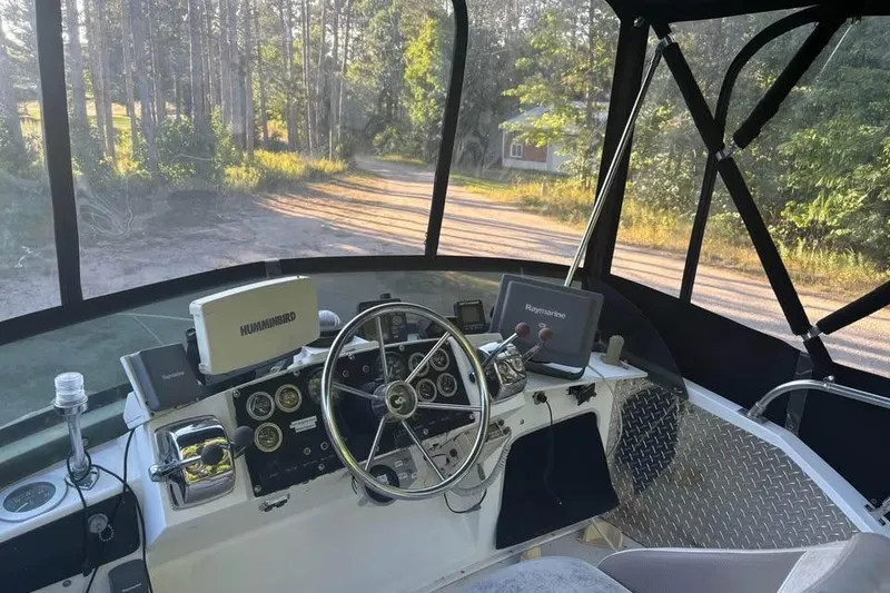 Slide: The Image of 1977 Bertram 28 Flybridge helm with steering wheel and navigation equipment. - 9