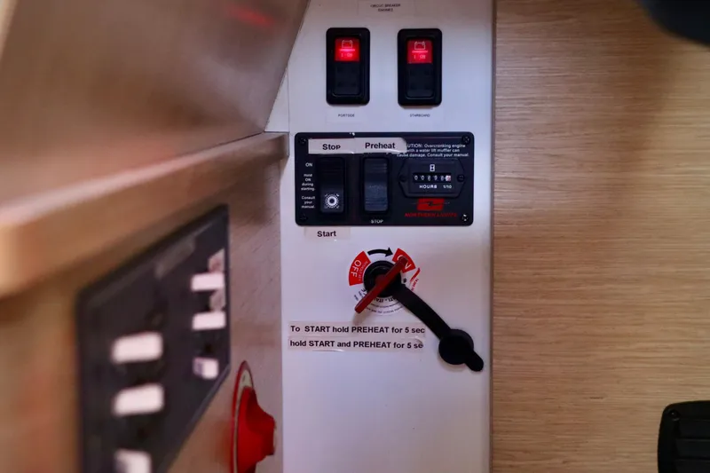 Slide: The Image of Control panel of a 2017 Outremer 51 sailboat with switches and instructions. - 100