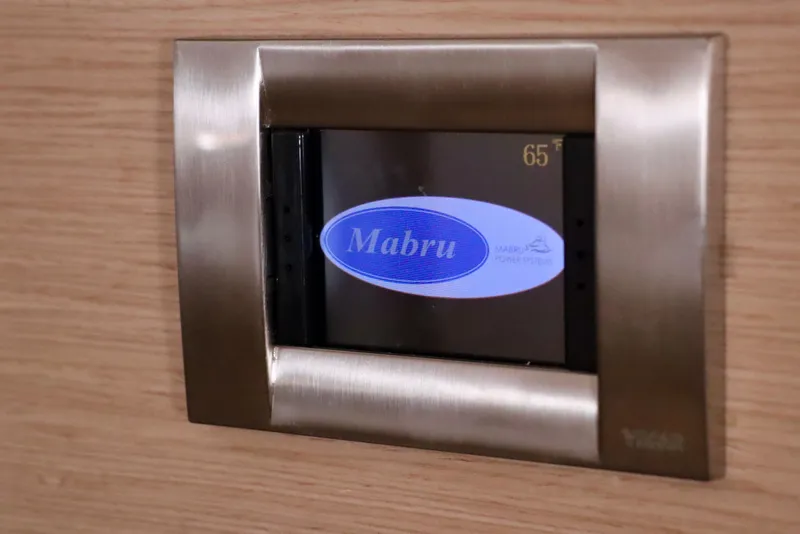 Slide: The Image of Mabru power system display on 2017 Outremer 51 yacht, showing temperature at 65°F. - 102