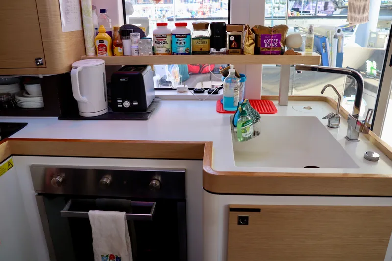 Slide: The Image of Modern kitchen in a 2017 Outremer 51 yacht with sink, oven, and appliances. - 113