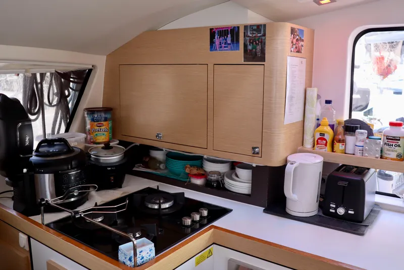 Slide: The Image of Modern kitchen in a 2017 Outremer 51 yacht with appliances and storage. - 114