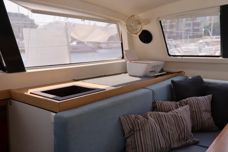 Slide: The Image of Interior of a 2017 Outremer 51 yacht with cozy seating and striped cushions. - 118