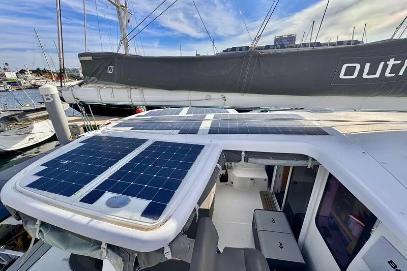Slide: The Image of 2017 Outremer 51 catamaran with solar panels on deck, docked at marina. - 13