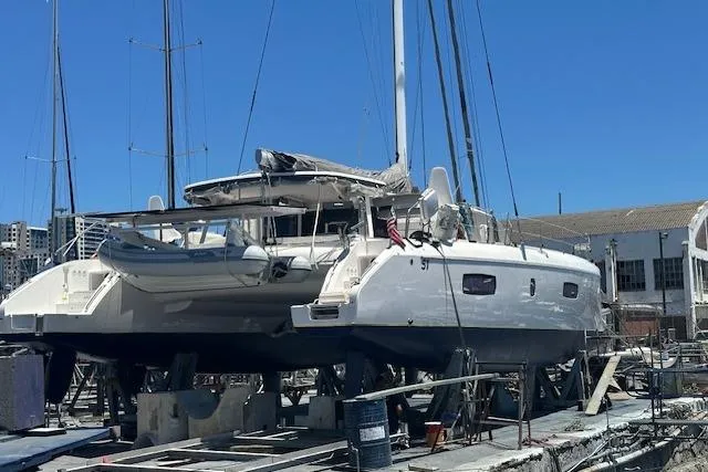 Slide: The Image of 2017 Outremer 51 catamaran on dry dock, with blue sky background. - 139