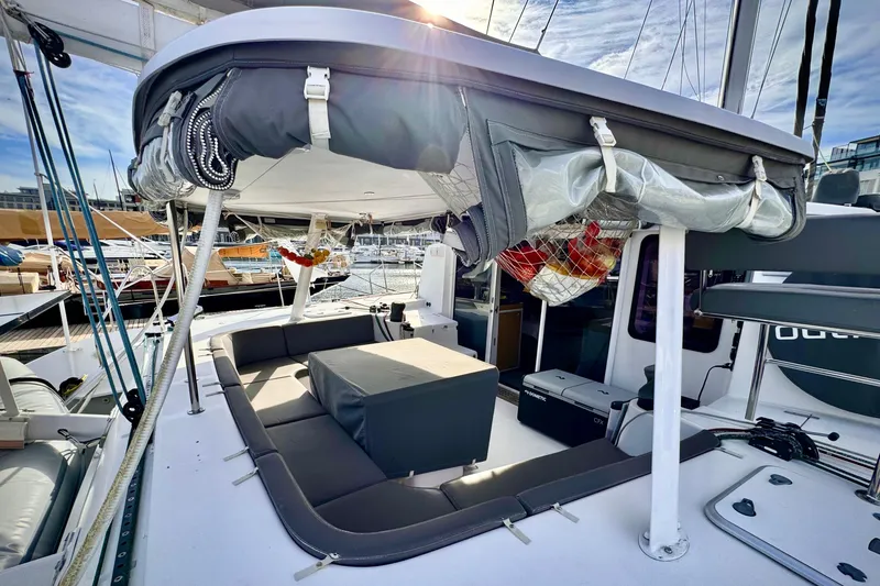 Slide: The Image of 2017 Outremer 51 catamaran deck with seating and covered cockpit area. - 16