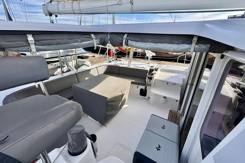 Slide: The Image of 2017 Outremer 51 catamaran cockpit with seating and covered table. - 17