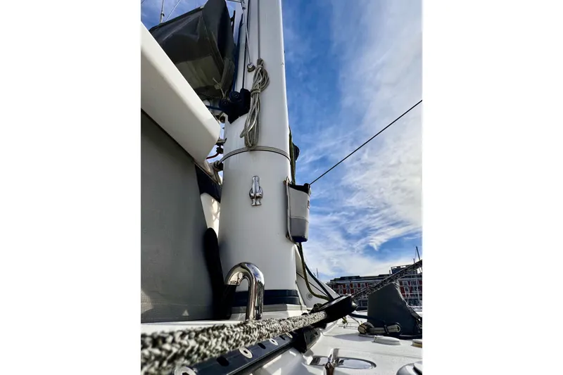 Slide: The Image of 2017 Outremer 51 sailboat mast against a blue sky with clouds. - 18
