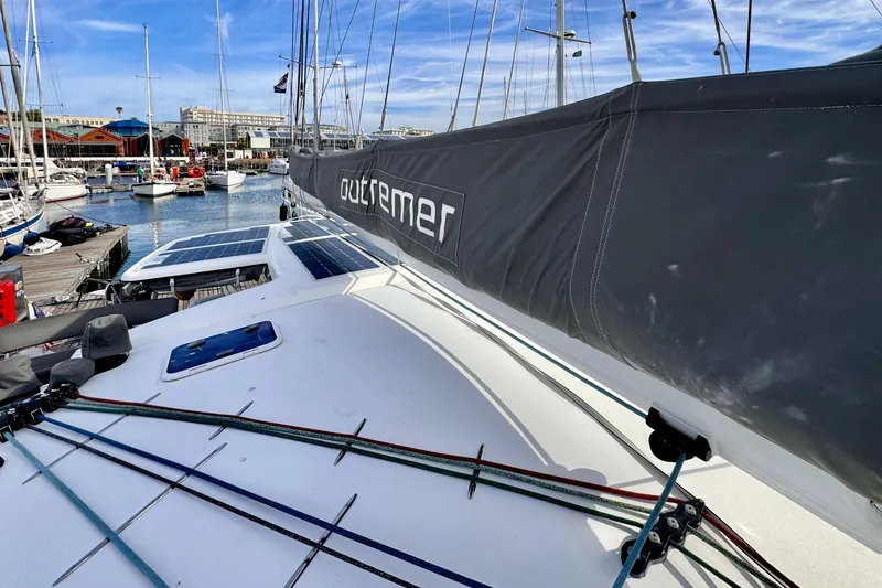 Slide: The Image of 2017 Outremer 51 catamaran docked at marina with solar panels and rigging. - 20