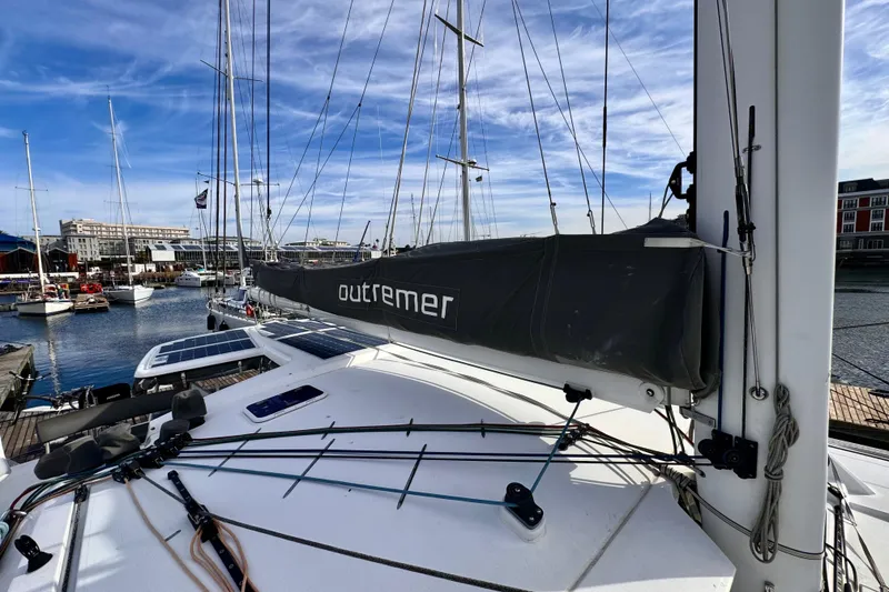 Slide: The Image of 2017 Outremer 51 catamaran docked at marina with clear blue sky. - 21