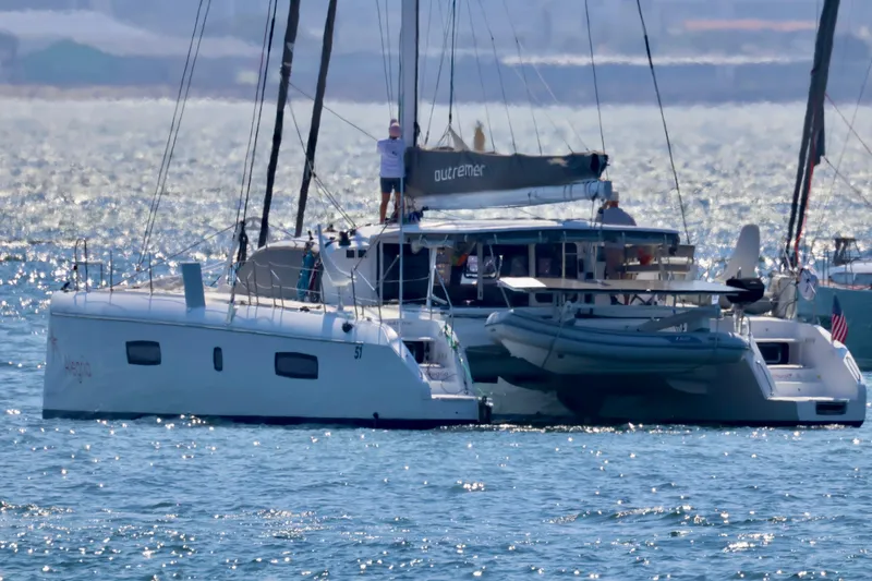 Slide: The Image of 2017 Outremer 51 catamaran sailing on a sunny day with a dinghy attached. - 4