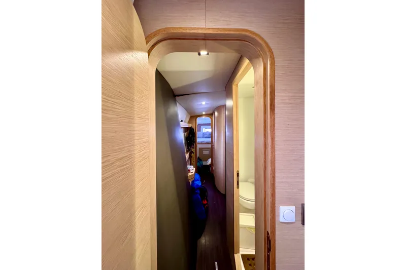Slide: The Image of Interior hallway of 2017 Outremer 51 yacht, featuring modern wood finishes and compact design. - 40