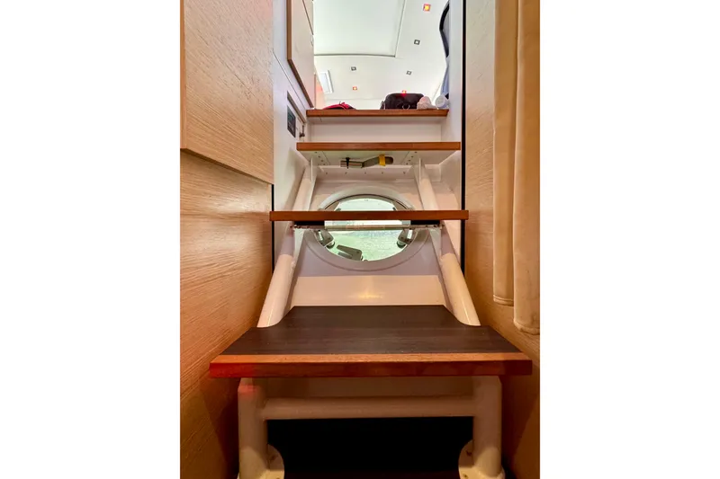 Slide: The Image of Staircase inside 2017 Outremer 51 yacht with porthole view. - 42