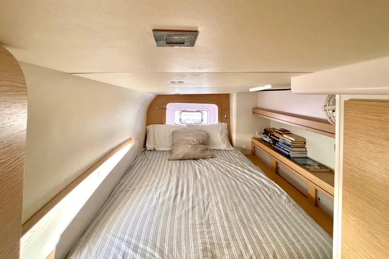 Slide: The Image of Cozy cabin interior of 2017 Outremer 51 yacht with bed and bookshelves. - 44