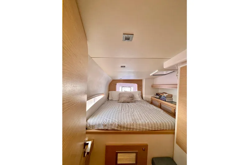 Slide: The Image of Cozy cabin interior of 2017 Outremer 51 yacht with bed and bookshelves. - 45