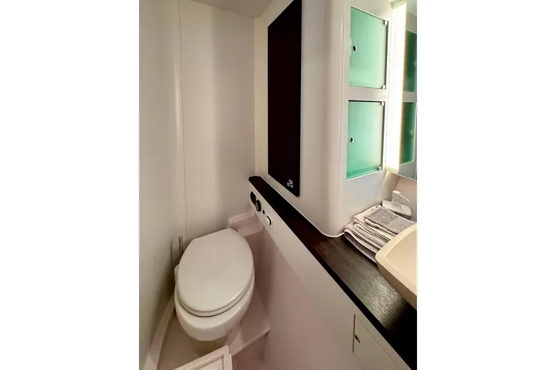 Slide: The Image of Bathroom interior of 2017 Outremer 51 yacht with modern fixtures and storage. - 50