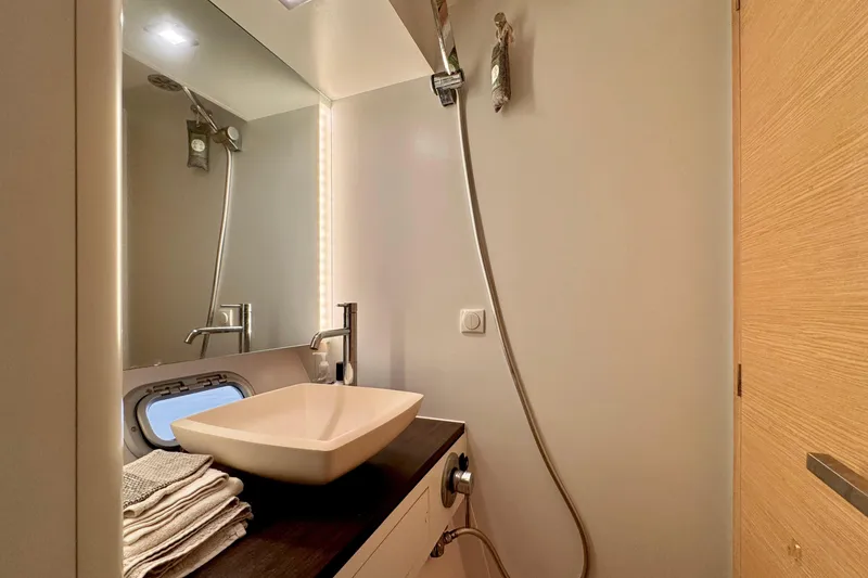 Slide: The Image of Modern bathroom interior on 2017 Outremer 51 yacht, featuring sleek sink and shower. - 51