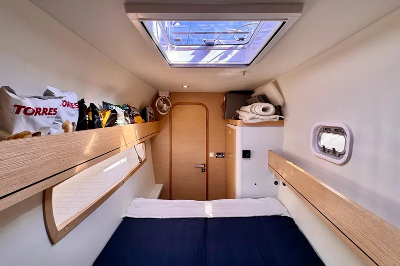 Slide: The Image of Cozy cabin interior of 2017 Outremer 51 yacht with skylight and storage. - 54