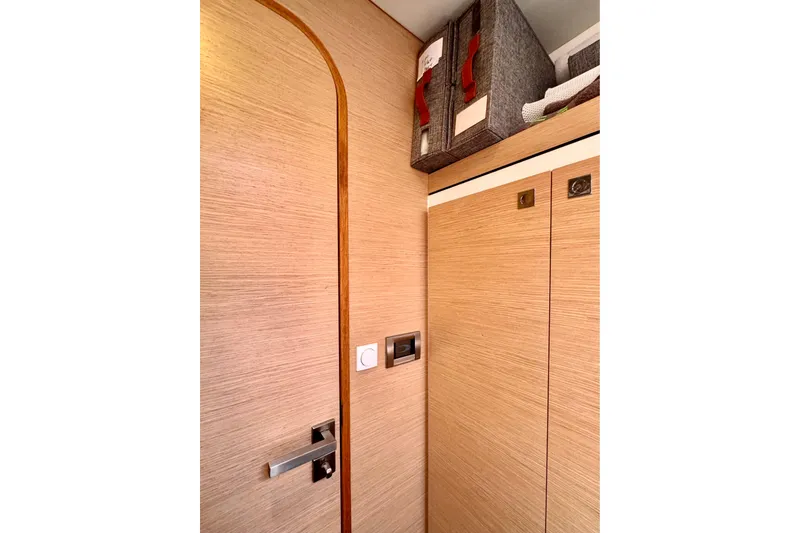 Slide: The Image of Interior of 2017 Outremer 51 yacht with wooden paneling and storage baskets. - 55