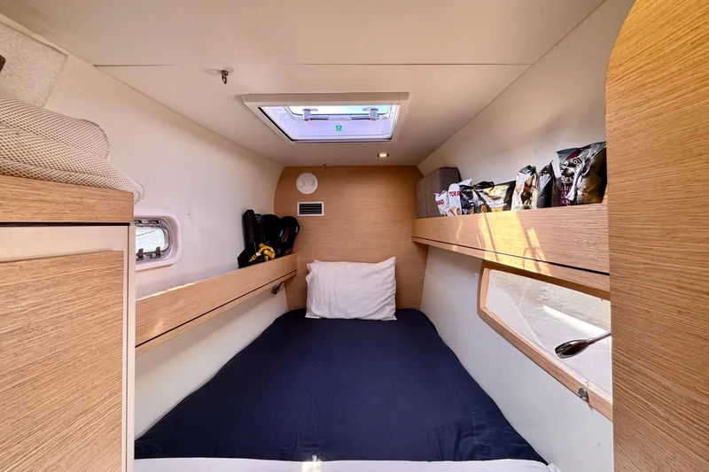 Slide: The Image of Cozy cabin interior of 2017 Outremer 51 yacht with skylight and storage shelves. - 56