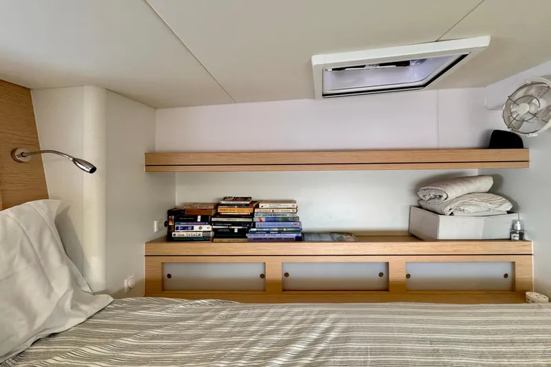 Slide: The Image of Cozy cabin interior of 2017 Outremer 51 with books and bedding on wooden shelves. - 63