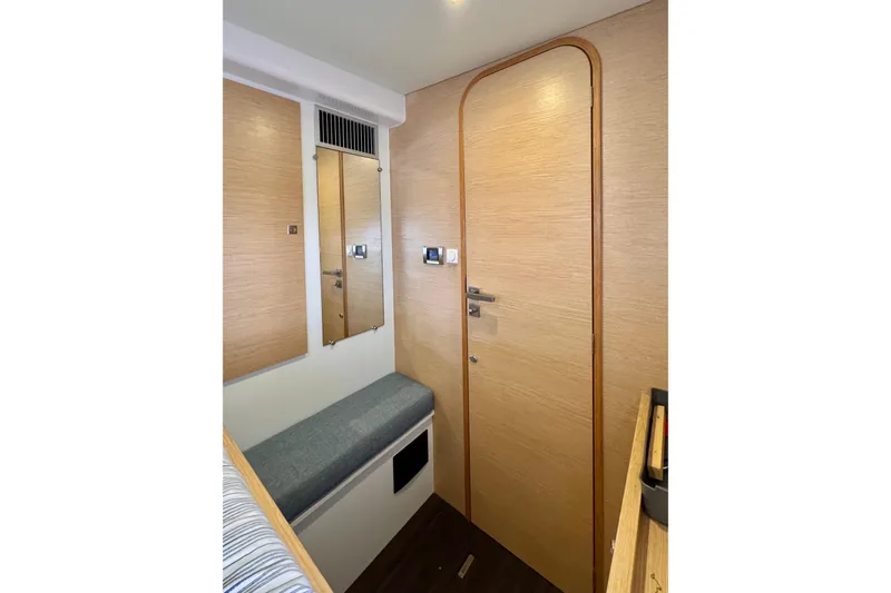 Slide: The Image of Interior of 2017 Outremer 51 yacht with wooden door and seating area. - 65