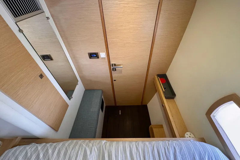 Slide: The Image of Interior of 2017 Outremer 51 yacht cabin with modern wood finish. - 66