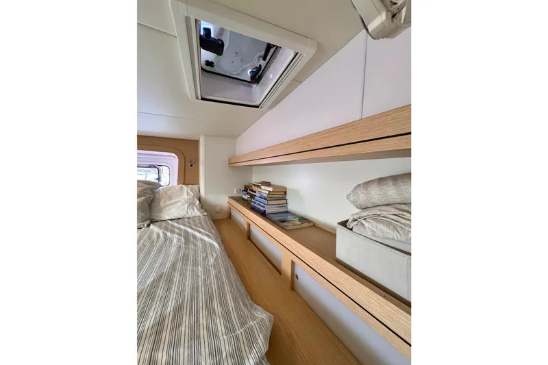 Slide: The Image of Cozy cabin interior of 2017 Outremer 51 yacht with bed, books, and skylight. - 67