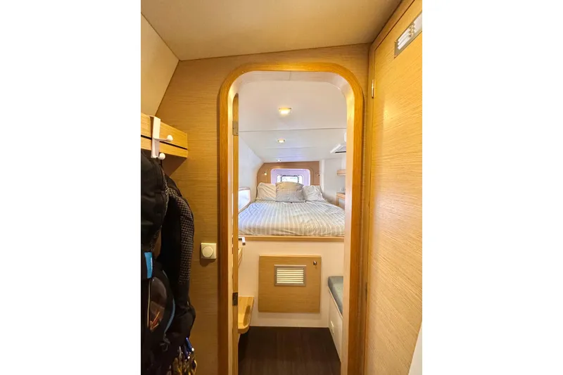 Slide: The Image of Cozy cabin interior of 2017 Outremer 51 yacht with bed and wooden accents. - 69